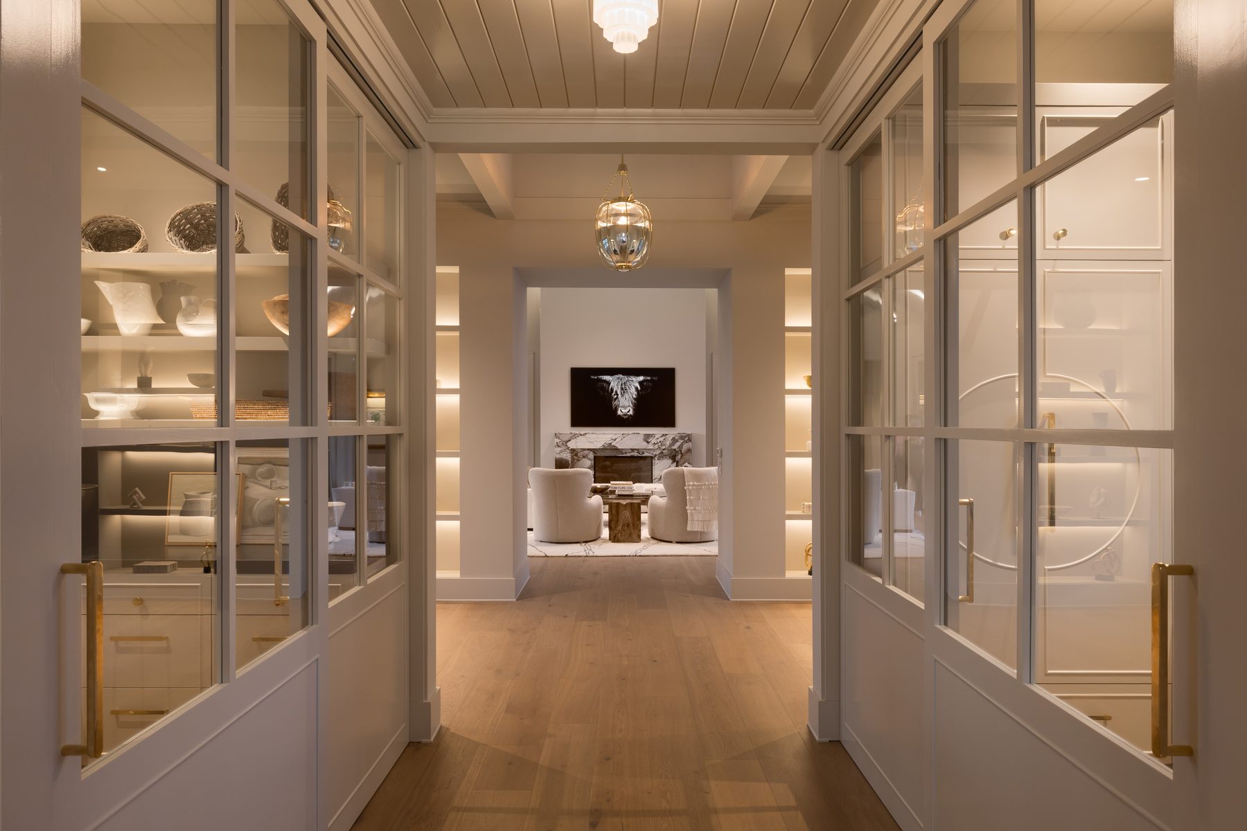 Glass-paneled hallway leading toward the living room