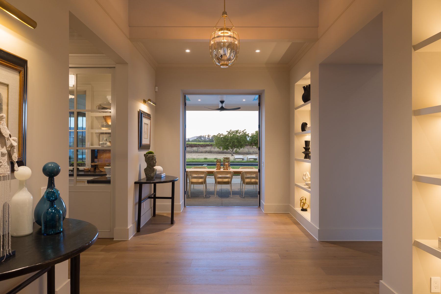 Great room opening to the covered terrace, pool, and vineyard views