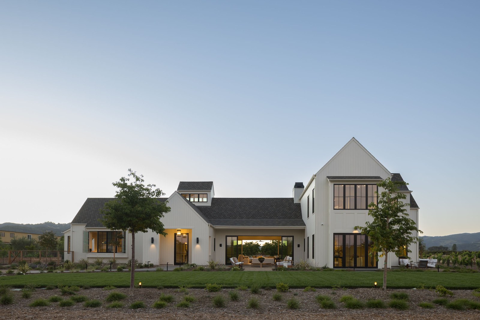 Twilight exterior view of the residence and surrounding grounds